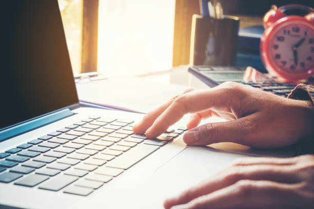 istock Man's using laptop with blank screen on desk in home interior. Business concept 655224358