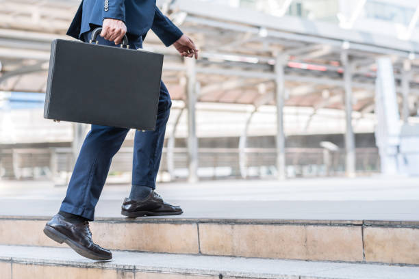 istock Businessman walking upward on the stair 655229022