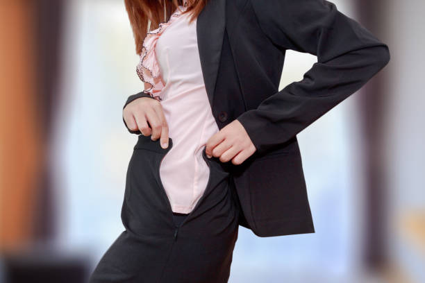 istock Chubby business woman cannot button up her clothes in her bed room. belly fat concept. 655229084