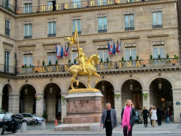 Monument of Jeanne d'Arc at the Pyramids area in Paris Paris, France - October 21, 2005 - A monument of Jeanne d'Arc (The Maid of Orleans) at the place des Pyramides near Rue de Rivoli on a cloudy autumn day place des pyramides stock pictures, royalty-free photos & images