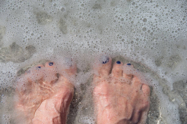 istock feet in ocean water 655235222