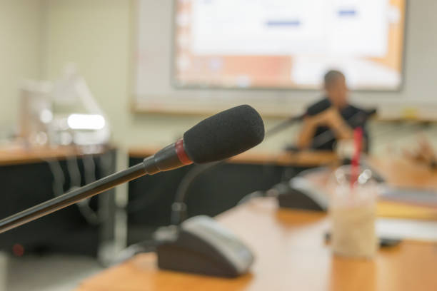istock Microphone of conference hall room background 655237870