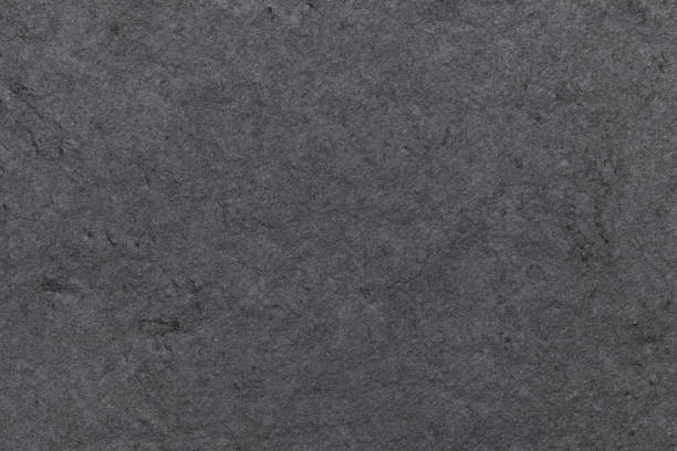 Dark gray background of natural slate. Texture black stone closeup. Dark gray background of natural slate. Texture black stone close up. floor length stock pictures, royalty-free photos & images