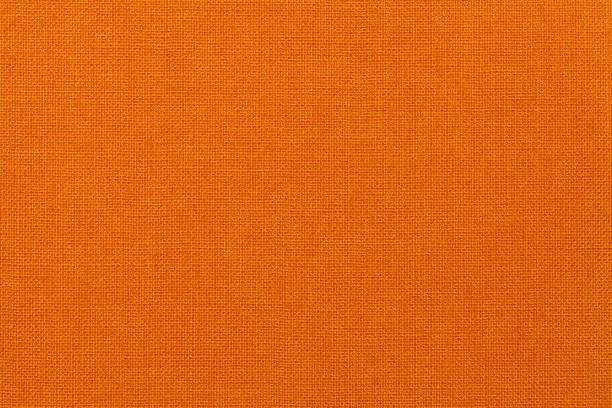 istock Bright orange background from textile material. Fabric with natural texture. 655246156