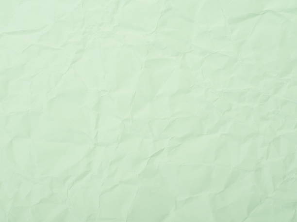 istock Green crumpled paper texture background 655248758