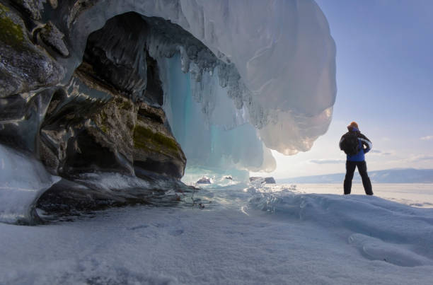 istock A man nearby a rock with the frozen wave. 655254192