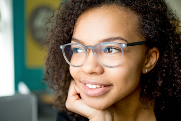 istock Smiling young woman in glasses looking away 655257464