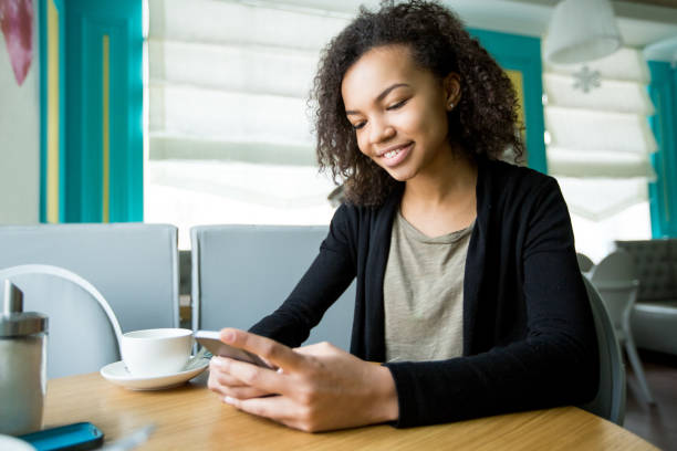 istock Smiling young woman texting message on smartphone 655257466