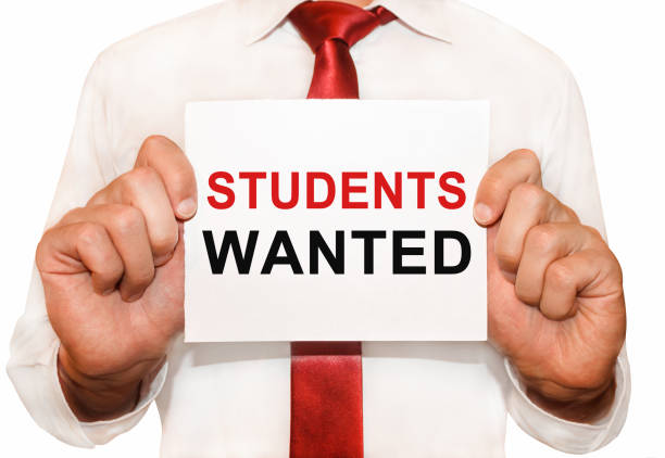 istock Man holding a card with a text Students Wanted 655262982