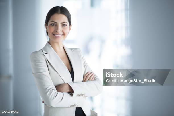 Smiling Female Business Leader With Arms Crossed Stock Photo - Download Image Now - Businesswoman, Women, Real Estate Agent