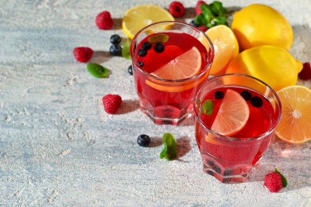 istock Cold berry drink with lemon and mint on a concrete background 655272556