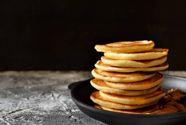 istock Hot, fresh Pancake in a cast iron skillet with nuts on a stone 655272602