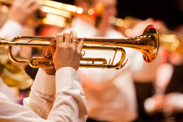 Trumpet in the hands of a musician Trumpet in the hands of a musician in the band closeup man trumpet stock pictures, royalty-free photos & images