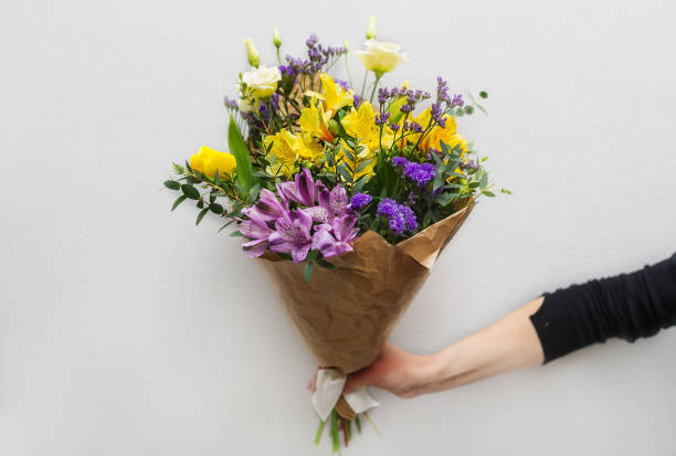istock Woman hand holding flowers 655275472