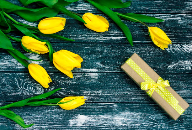 istock Greeting card with yellow tulips and gift box 655281786