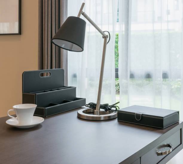 istock wooden table with white coffee cup and reading lamp in modern working room interior 655287302