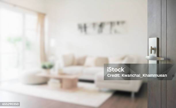 Opened Wooden Door To Modern Living Room Interior Stock Photo - Download Image Now - Living Room, Backgrounds, Defocused