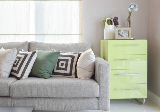 istock Cozy sofa with geometric pattern pillows and green sideboard in living corner 655291114