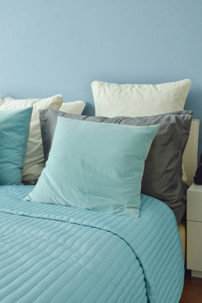 istock Blue, light blue and beige pillows on bed in blue wall bedroom 655291946