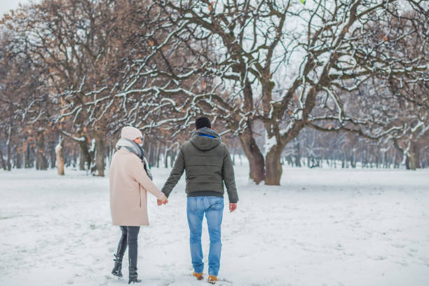 istock Happy loving couple walking in winter park 655292838