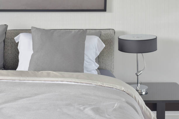 istock Dark gray pillow with comfy bed and black shade reading lamp 655295870