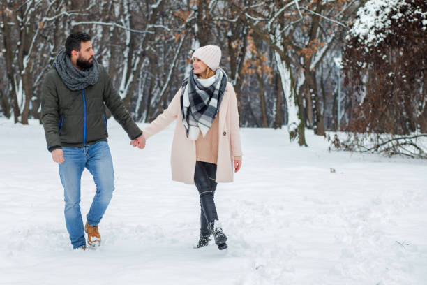 istock Happy loving couple walking in winter park 655296448