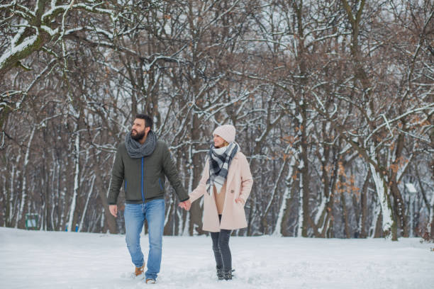 istock Happy loving couple walking in winter park 655298788