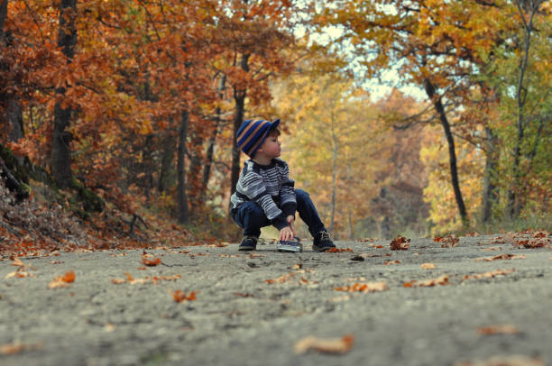 istock Boy play with car toy in park 655299368