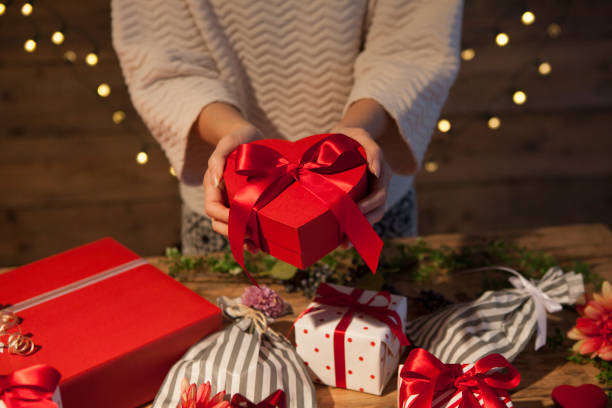 istock Heart shaped red ribbon gift box 655302770