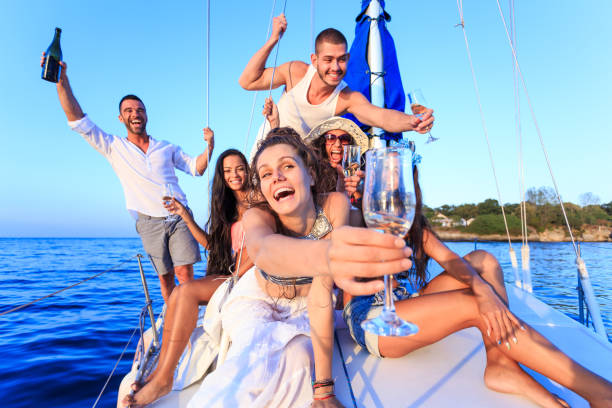 istock Cheerful friends having fun and drinking champagne on yacht 655303444