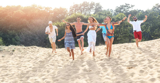 istock Group of happy young people having fun on beach 655303500