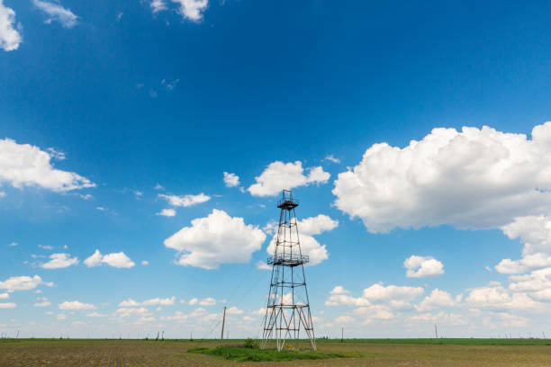 Replica of a 1900's oil derrick against a lovely blue sky.  Room for copy.  Rig located in Jefferson County, Texas.