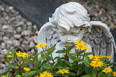 istock angel and yellow flowers on a grave 655307328