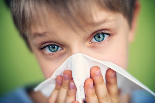 istock Cute sick little boy blowing nose 655313264