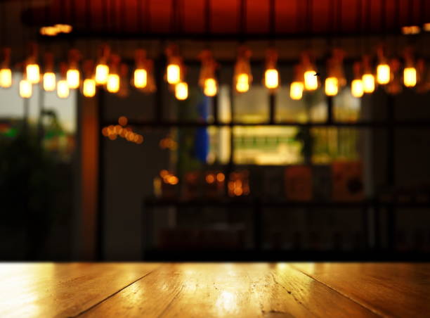 istock wood background blur lamp in pub or bar at night 655319562
