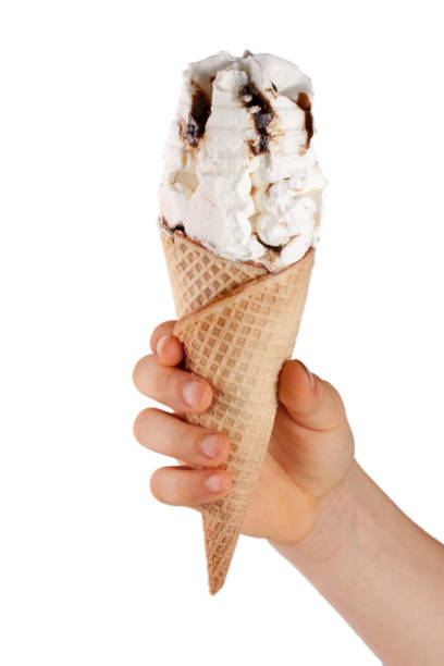 istock Ice cream cone in child's hand isolated on white background 655328620