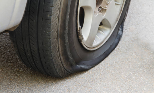 istock car wheel flat tire on the road. 655330736