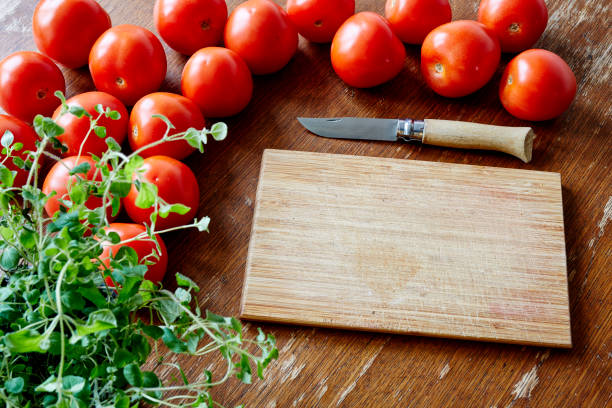 istock cutting board and knife with tomatoes and herbs 655331776