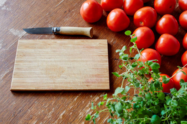 istock cutting board and knife in tomatoe scene 655332220