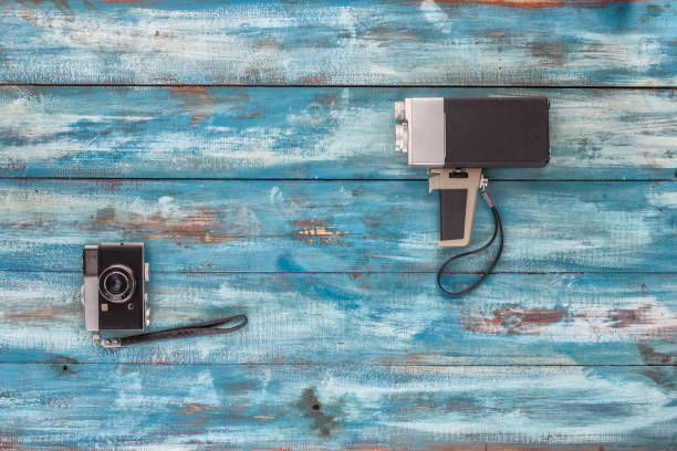 istock Video and photo camera on a blue old vintage background 655336000