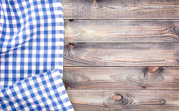 istock White old wooden table with blue checkered tablecloth, top view with copy space 655338550