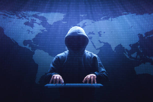 Anonymous Computer Hacker Anonymous computer hacker sitting in front of a virtual screen. computer crime stock pictures, royalty-free photos & images