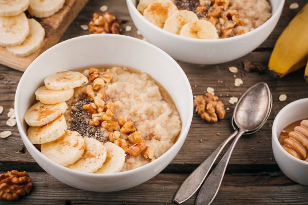 istock Breakfast bowl: oatmeal with banana, chia seeds, cinnamon, walnuts and honey 655349868
