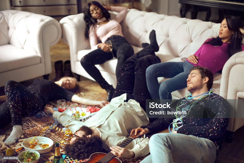 Resting after the party Young people are sleeping all over the floor and the couch Party - Social Event Stock Photo