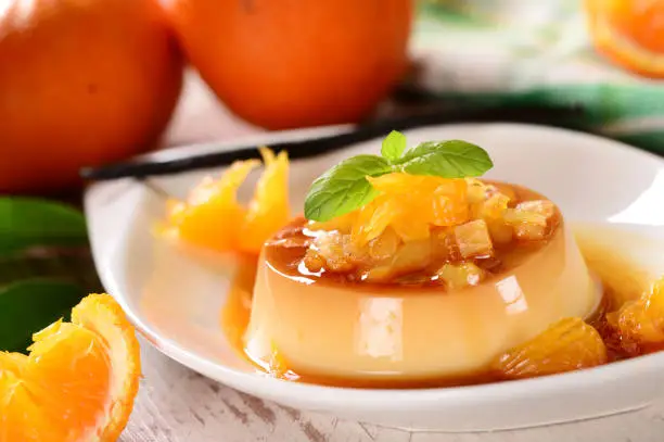 Italian dessert panna cotta with orange sauce