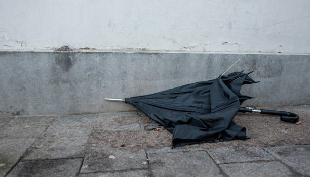 istock broken umbrella is left in the street 655367060