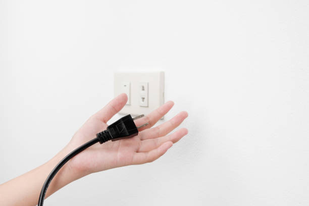 istock Plug on hand or unplug  outlet on white wall background 655370900