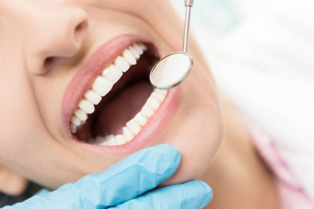 To have a healthy teeth ! Horizontal close-up image of woman having dental examination. dental equipment hand stock pictures, royalty-free photos & images