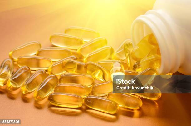 Fish Oil And Vitamin D Softgels Stock Photo - Download Image Now - Vitamin D, Nutritional Supplement, Sunlight