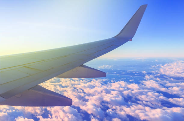 istock View from airplane window. Flying over the white clouds 655374304